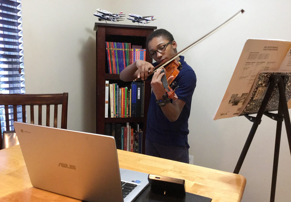 Robert takes a remote violin lesson with the Washington Conservatory of Music.